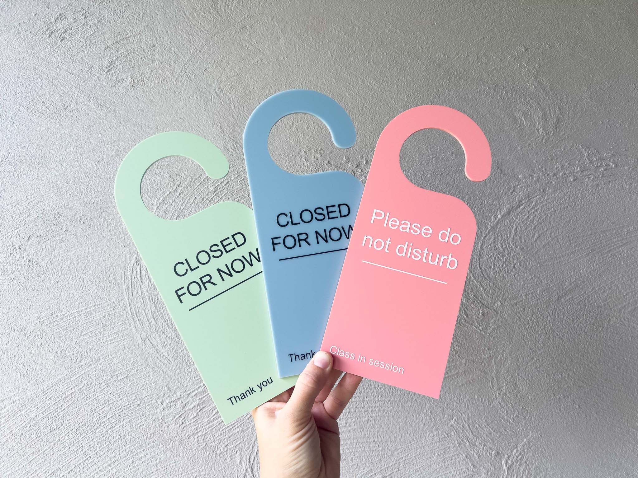 Multicoloured custom UV printed acrylic door hangers that say 'Closed For Now' & 'Please Do Not Disturb'.