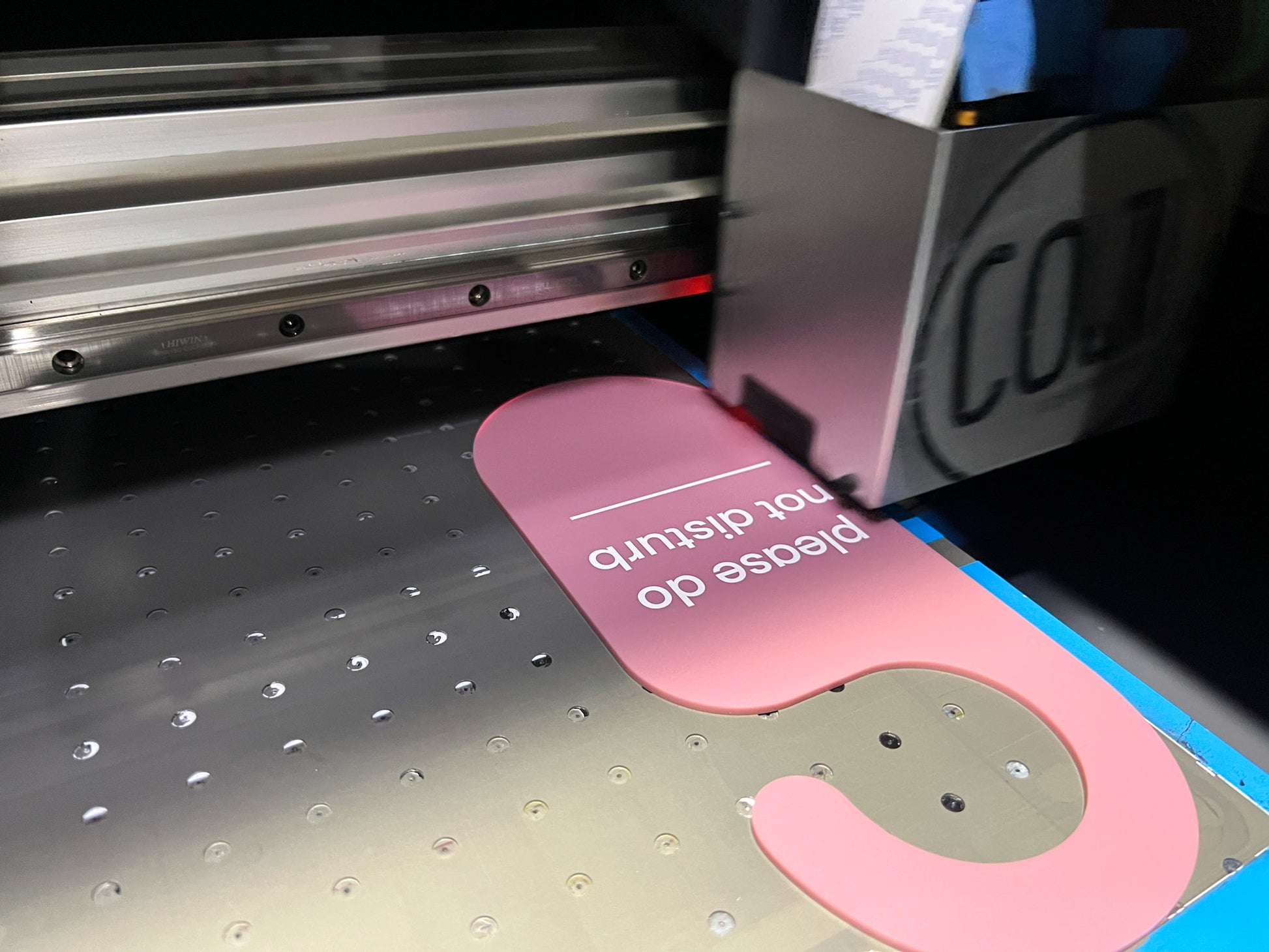 Custom acrylic door hanging being printed