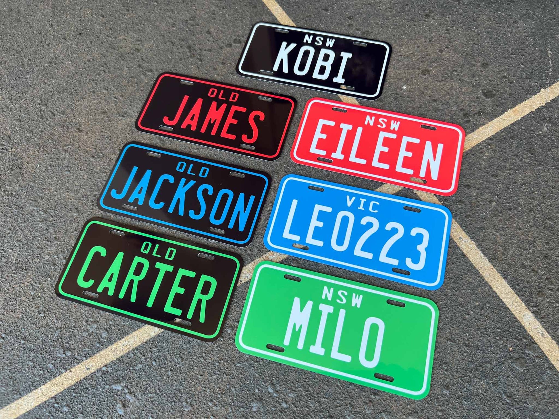 Collection of personalised kids mini plates on a textured surface