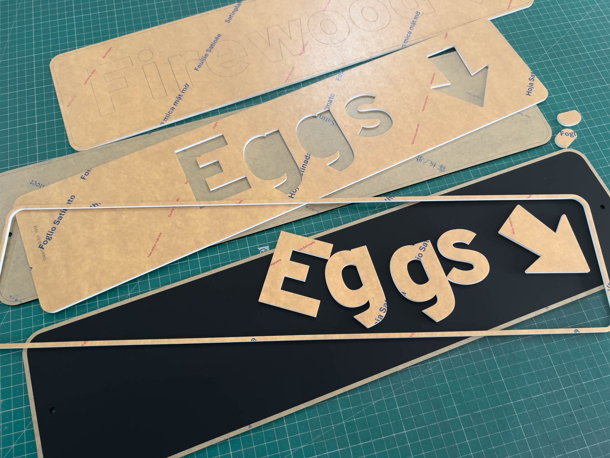 A collection of custom designed Arizona highway style street signs being cut and assembled.