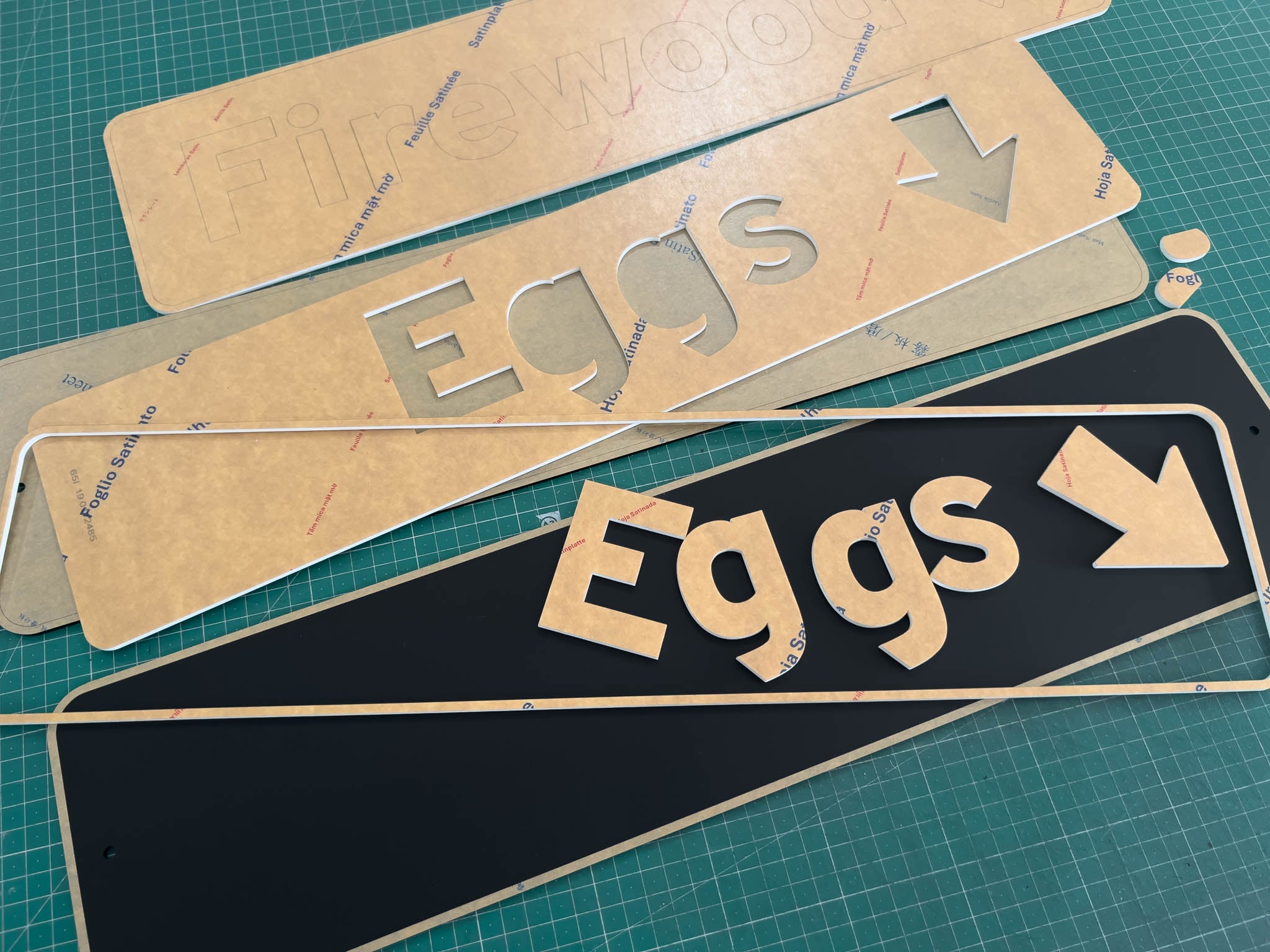 A collection of custom designed Arizona highway style street signs being cut and assembled.