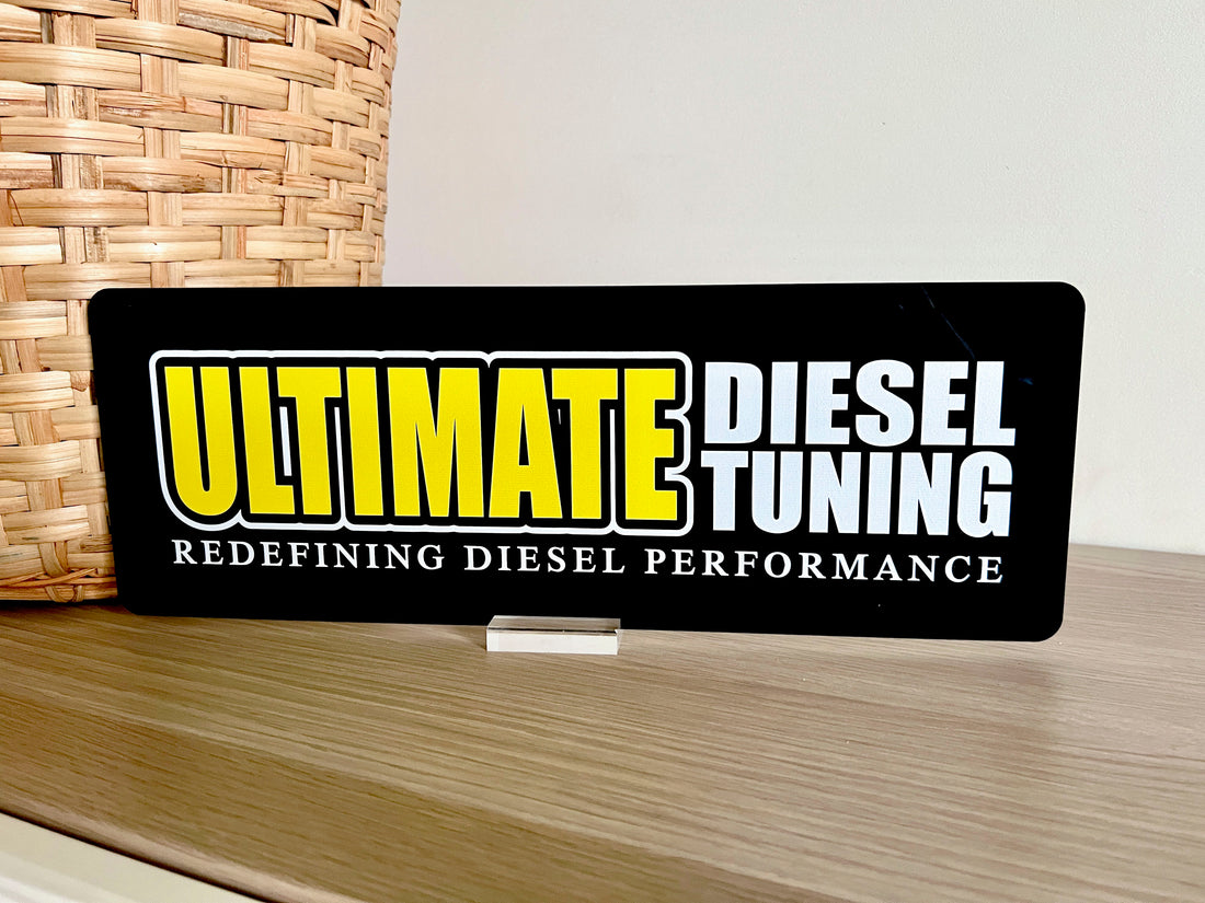 Custom table sign displaying an 'Ultimate Diesel Tuning' plate.