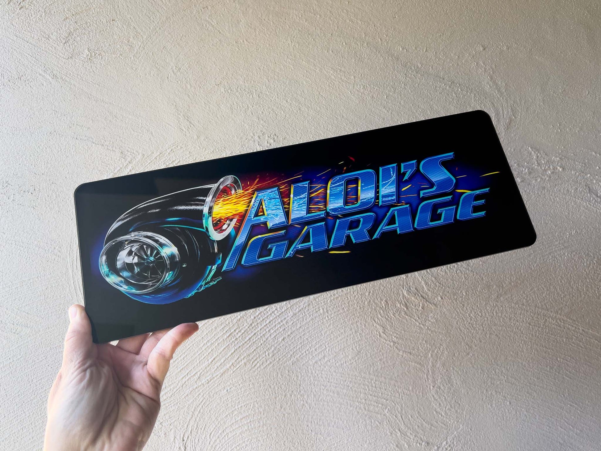 Custom printed premium glossy logo plate with 'Aloi's Garage'.