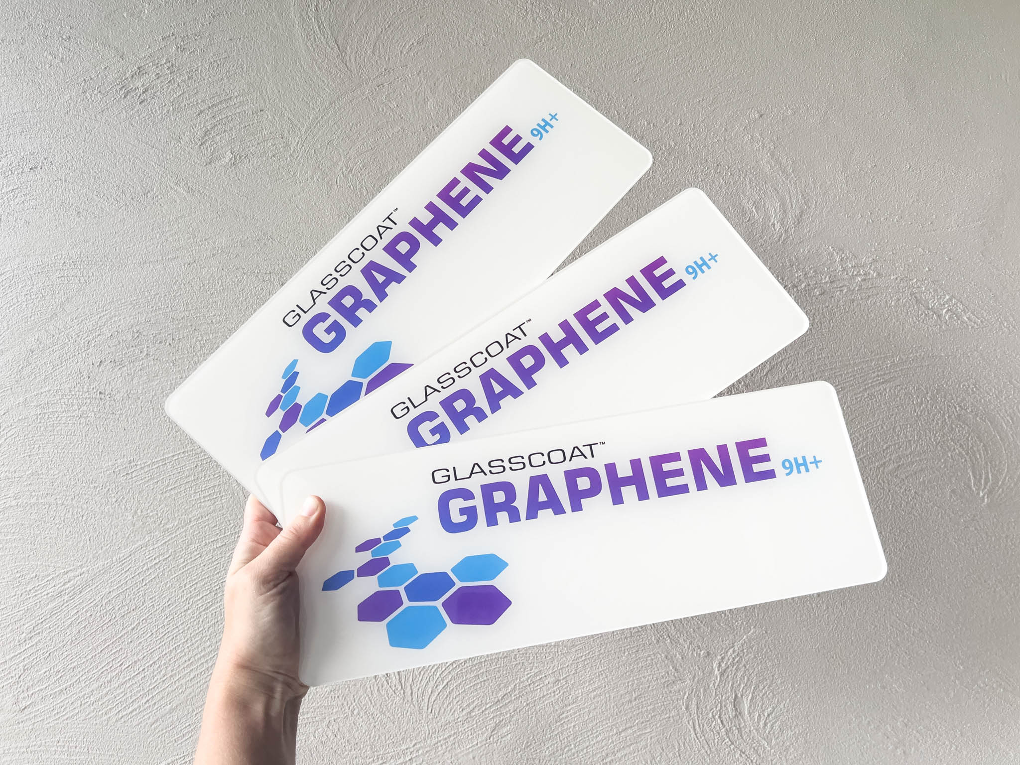 Three 'Glasscoat Graphene' logo plates in a high gloss finish.