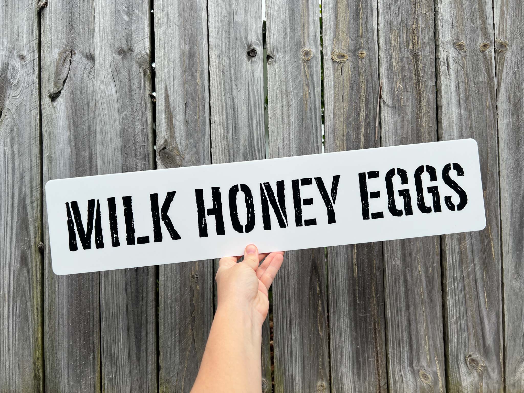 Custom printed stencil style sign with the words 'MILK HONEY EGGS' UV printed.