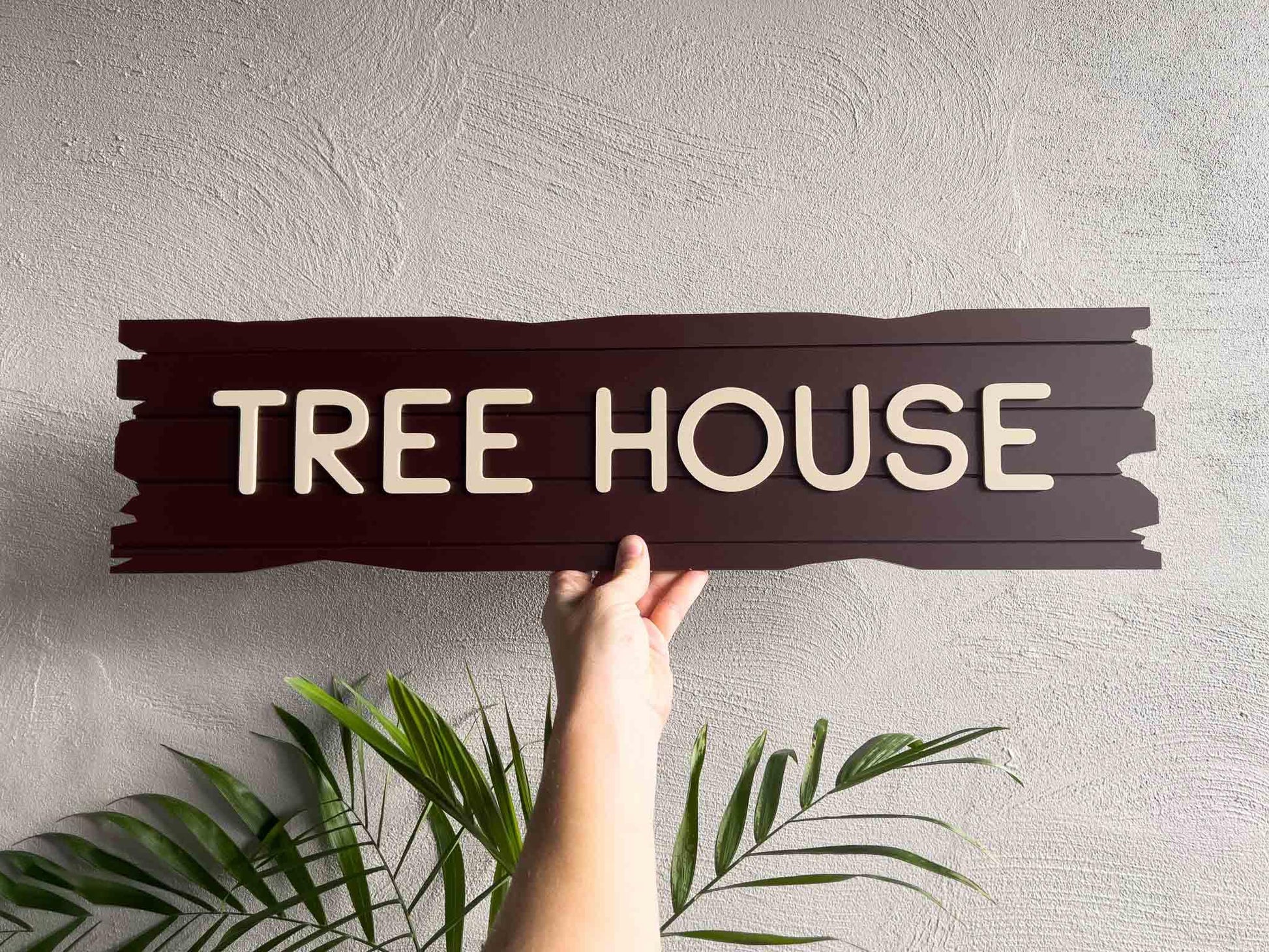 A custom acrylic timber-look plank sign that says 'TREE HOUSE' in a dark chocolate wood colour with beige text.