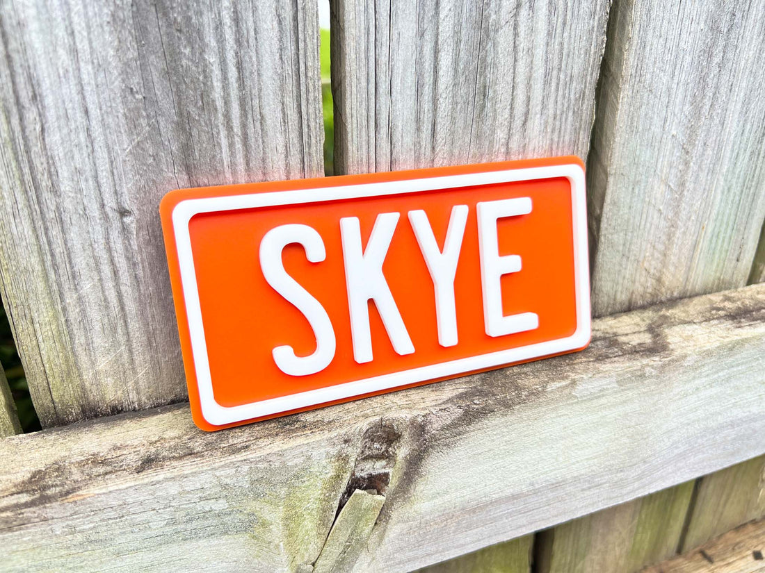 Personalised 3D mini acrylic sign with 'Skye' in a bright orange colour with white text.