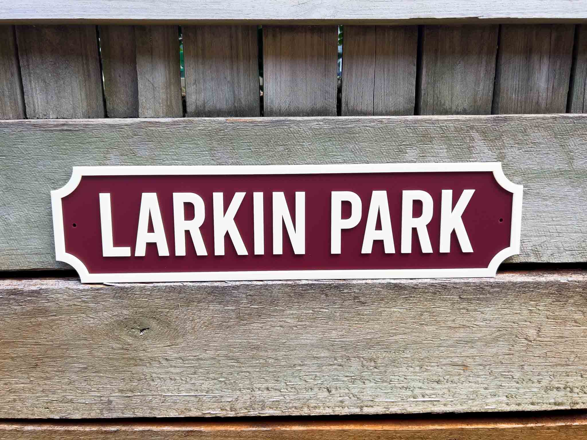 Custom vintage 3d acrylic street sign reading 'Larkin Park' on a wooden background