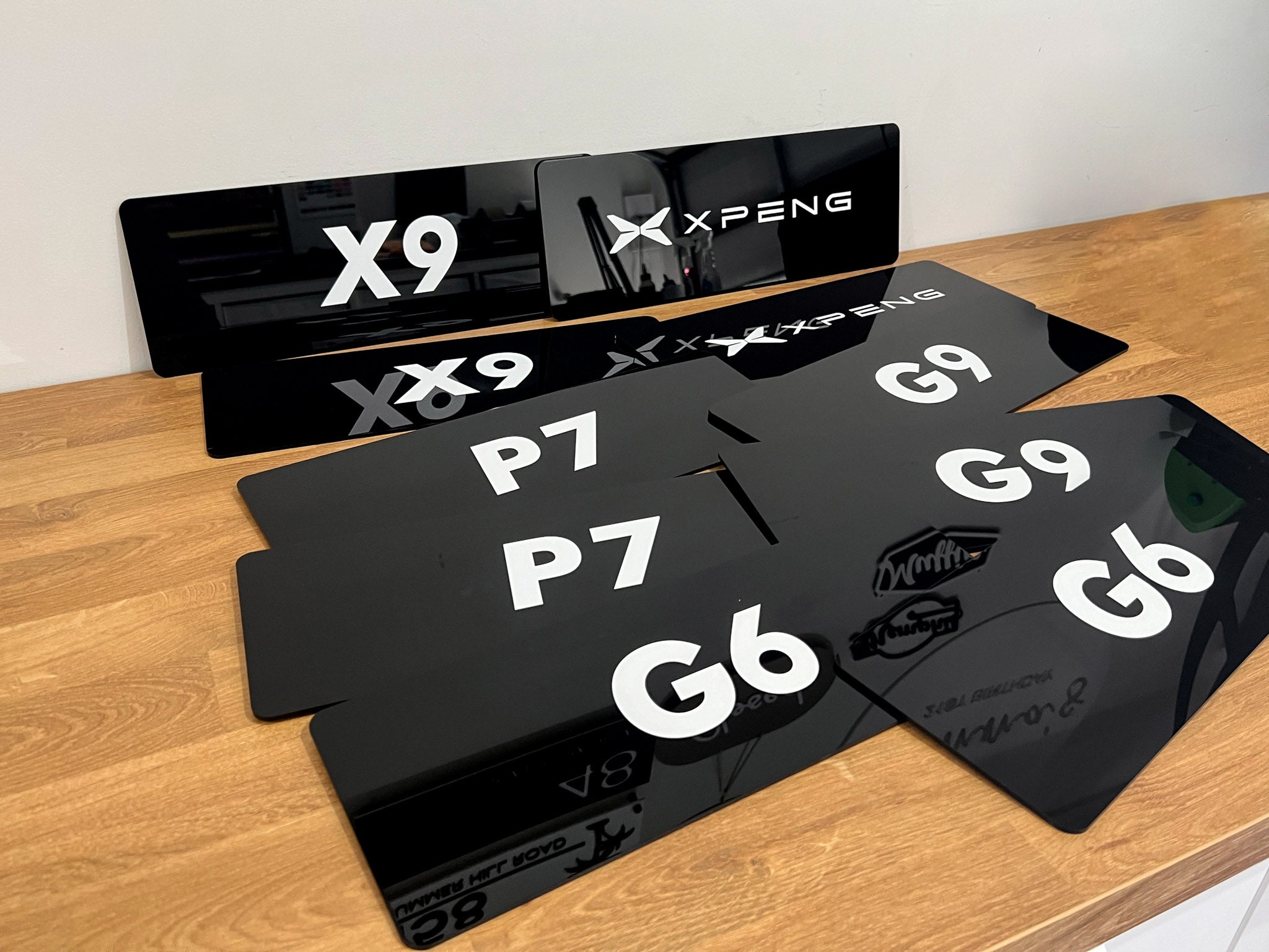 Set of black acrylic cover plates with the brand name 'XPENG' in white text.