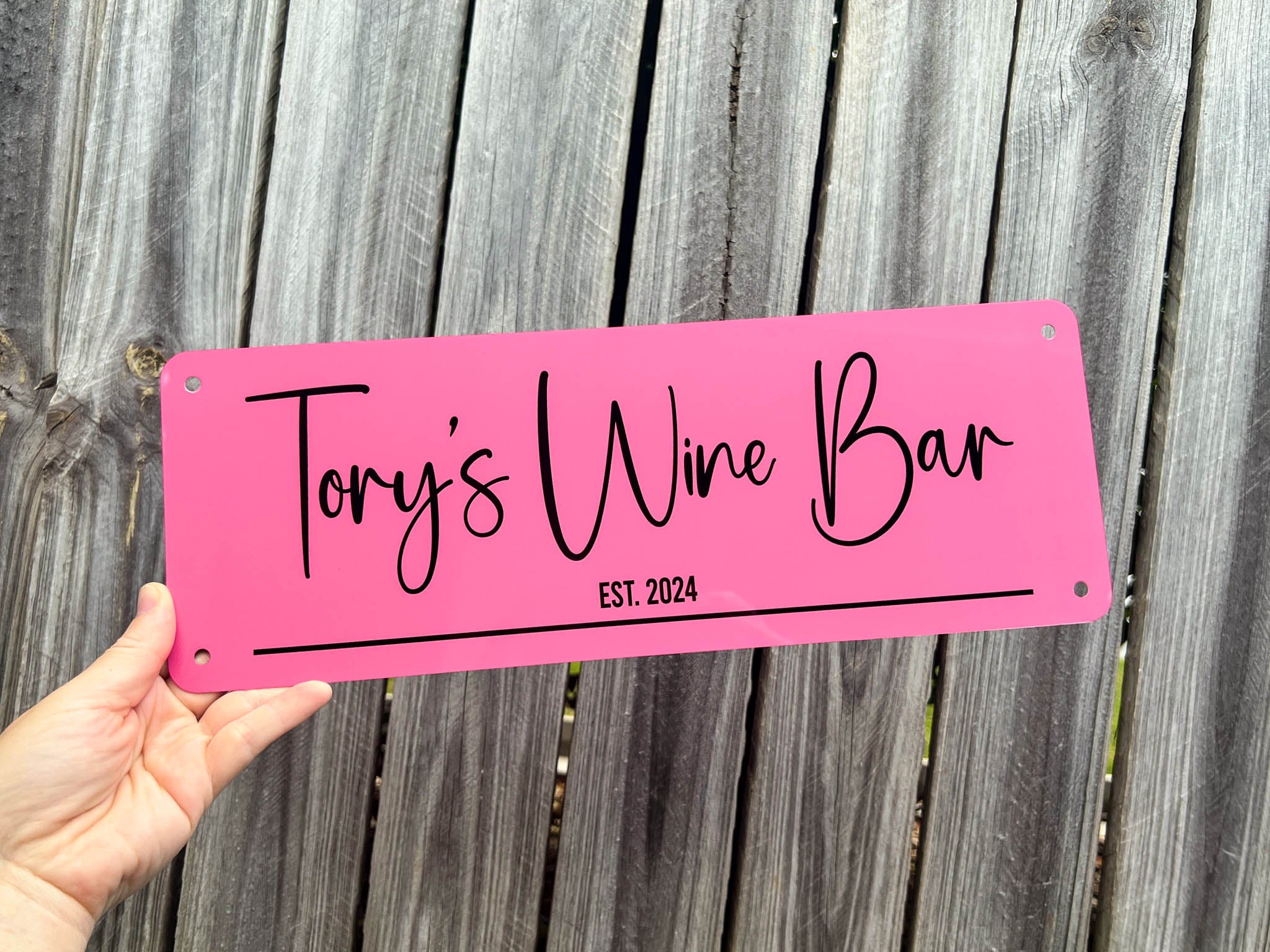 Personalised pink and black sign with the words 'Tory's Wine Bar Est. 2024'.