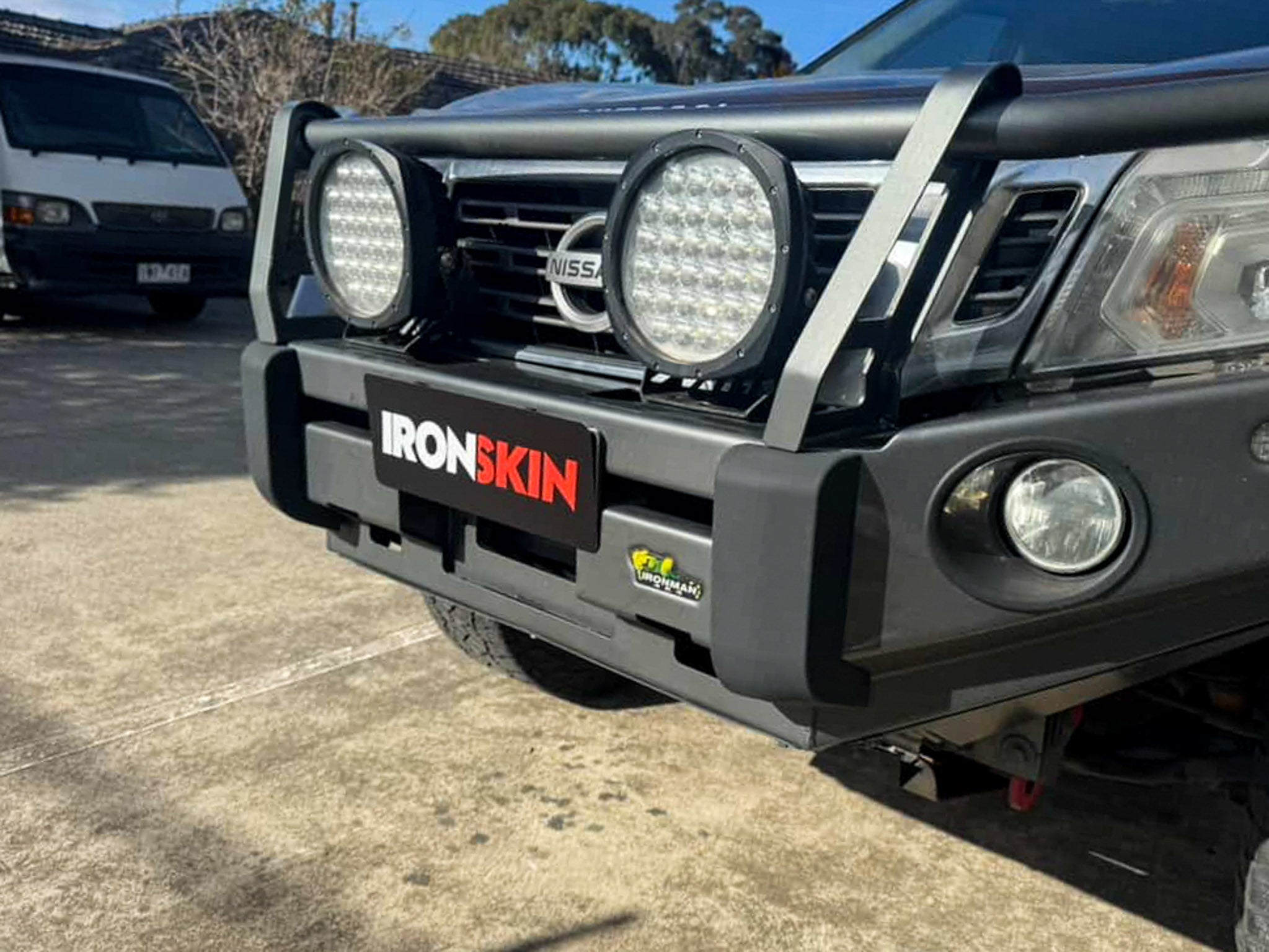 Nissan truck displaying a custom printed logo plate for Ironskin.