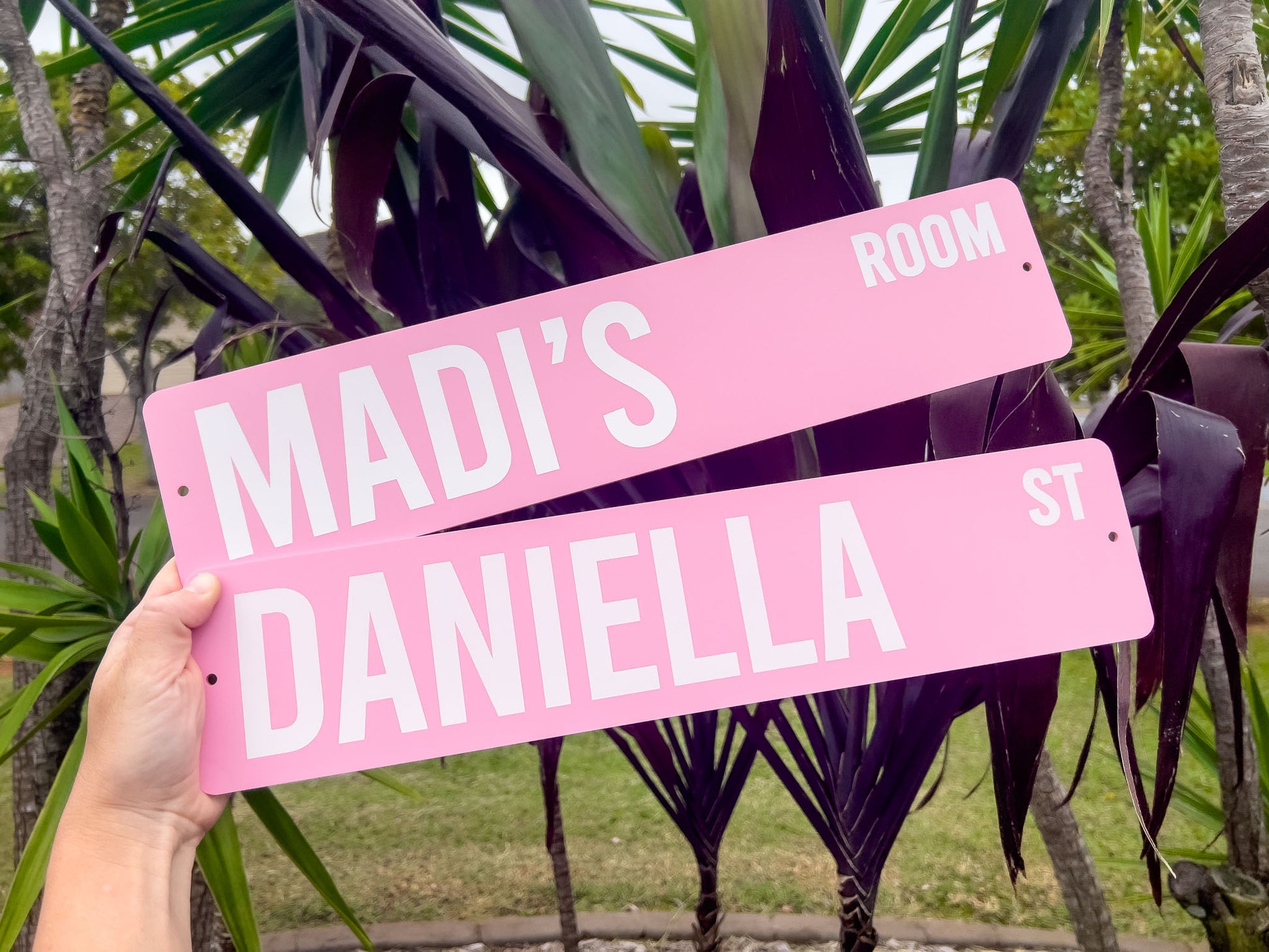 Two custom UV Printed light pink signs that read 'MADI'S ROOM', & 'DANIELLA ST' in white text.