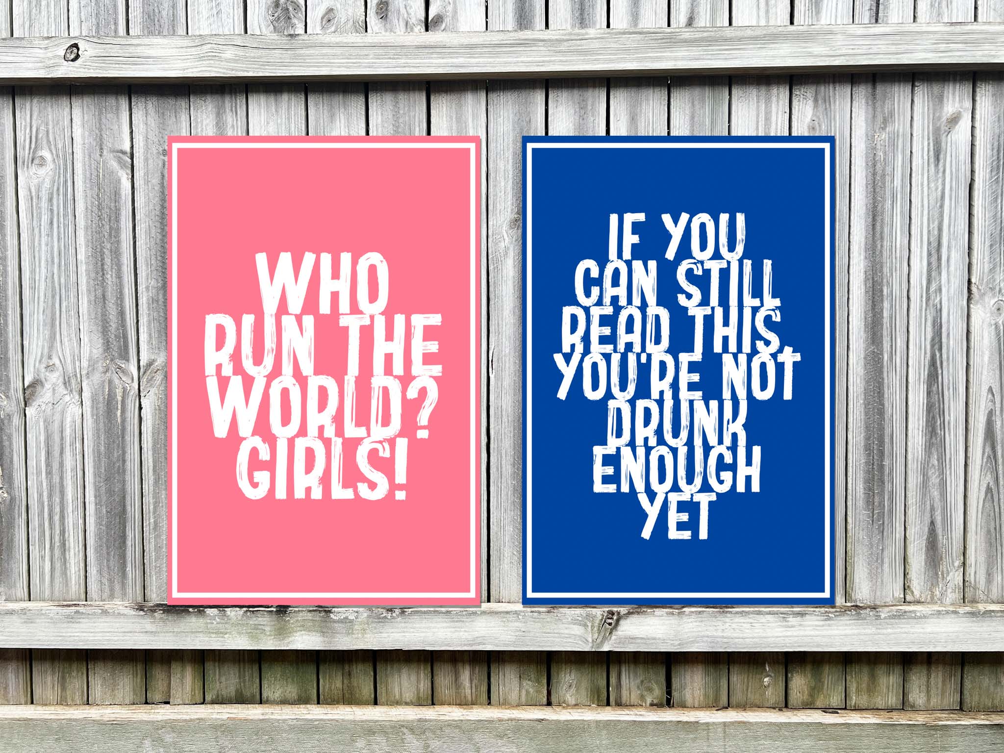 Two UV printed signs with motivational quotes on a wooden background