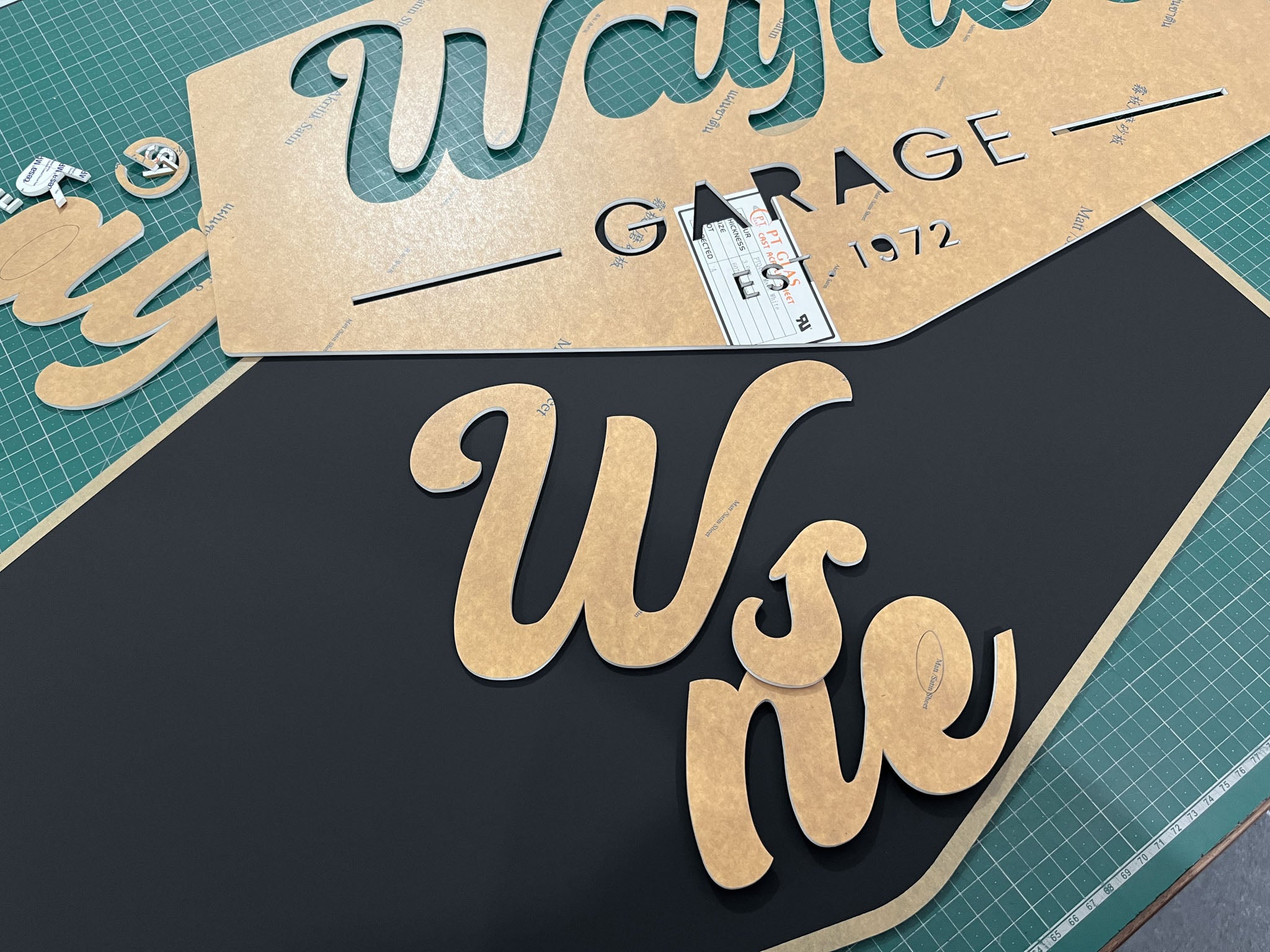 A custom Houston sign being assembled on a bench