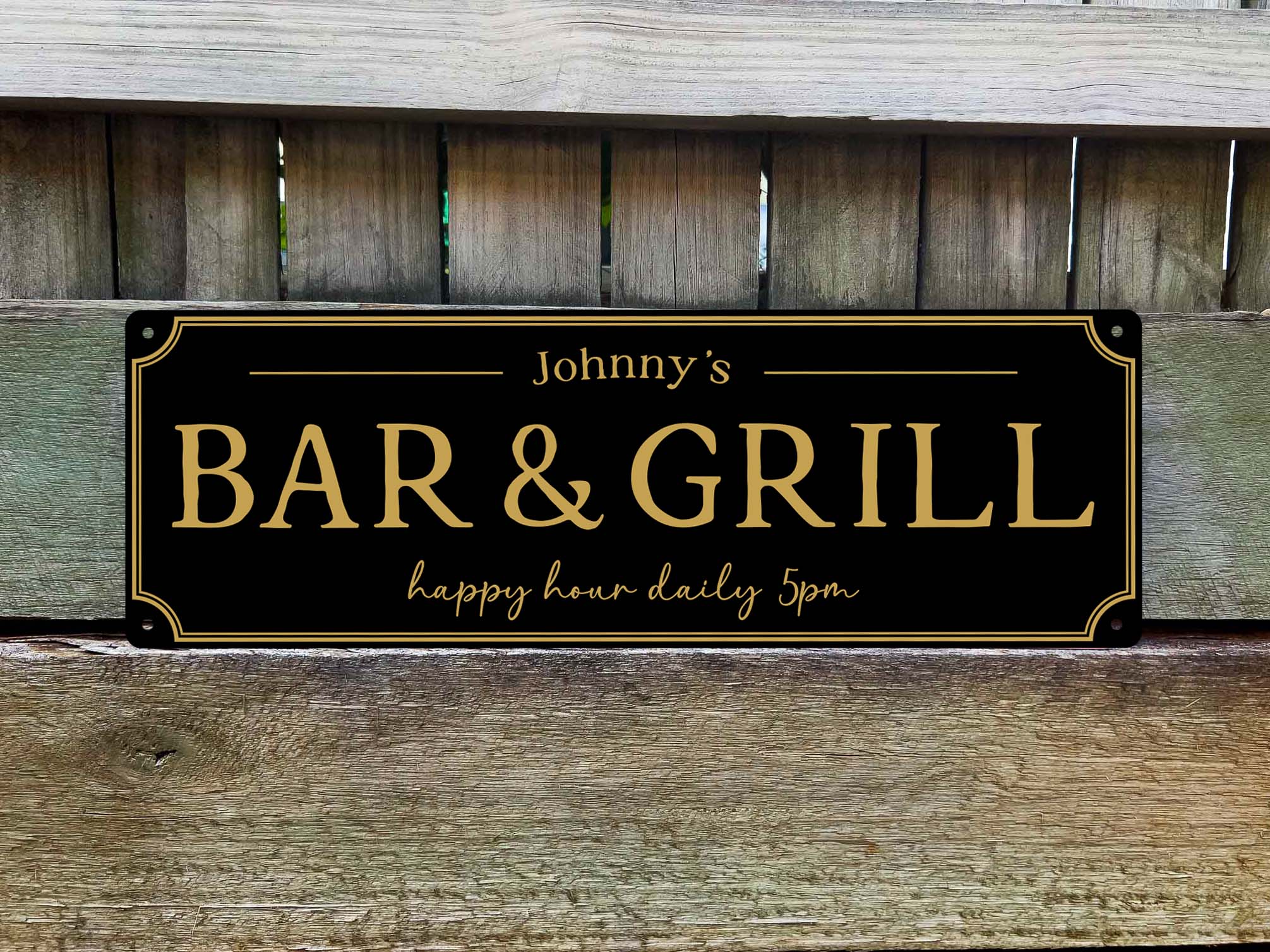 A custom printed black and gold 'Bar & Grill' sign personalised with a name and slogan.