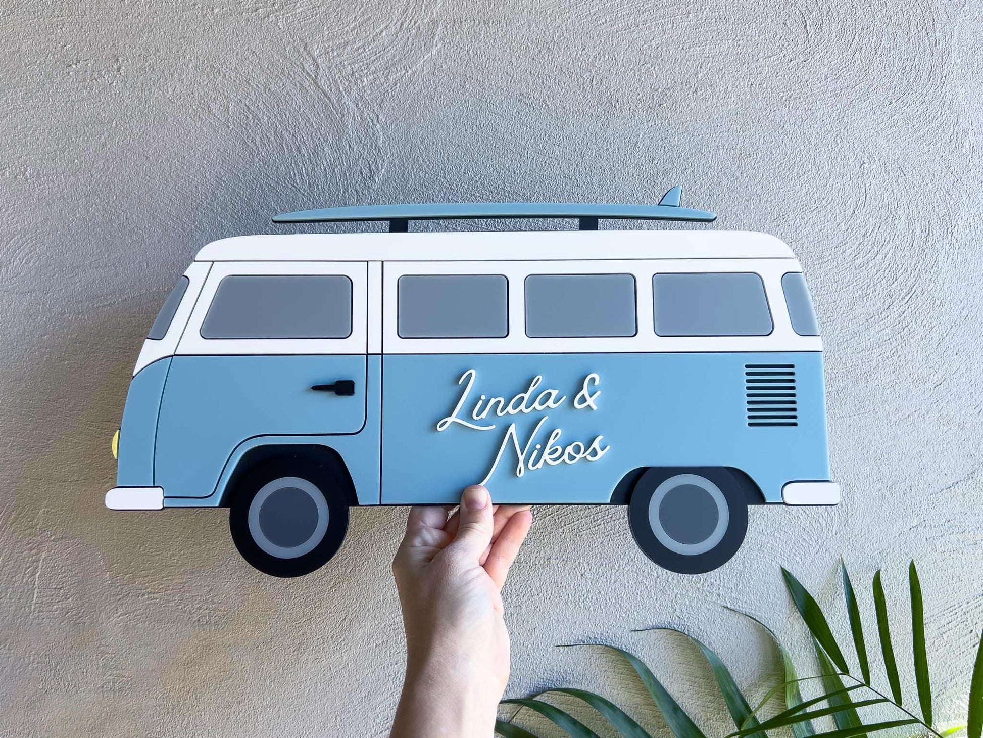 A custom made 3D acrylic blue surf van sign personalised with names.