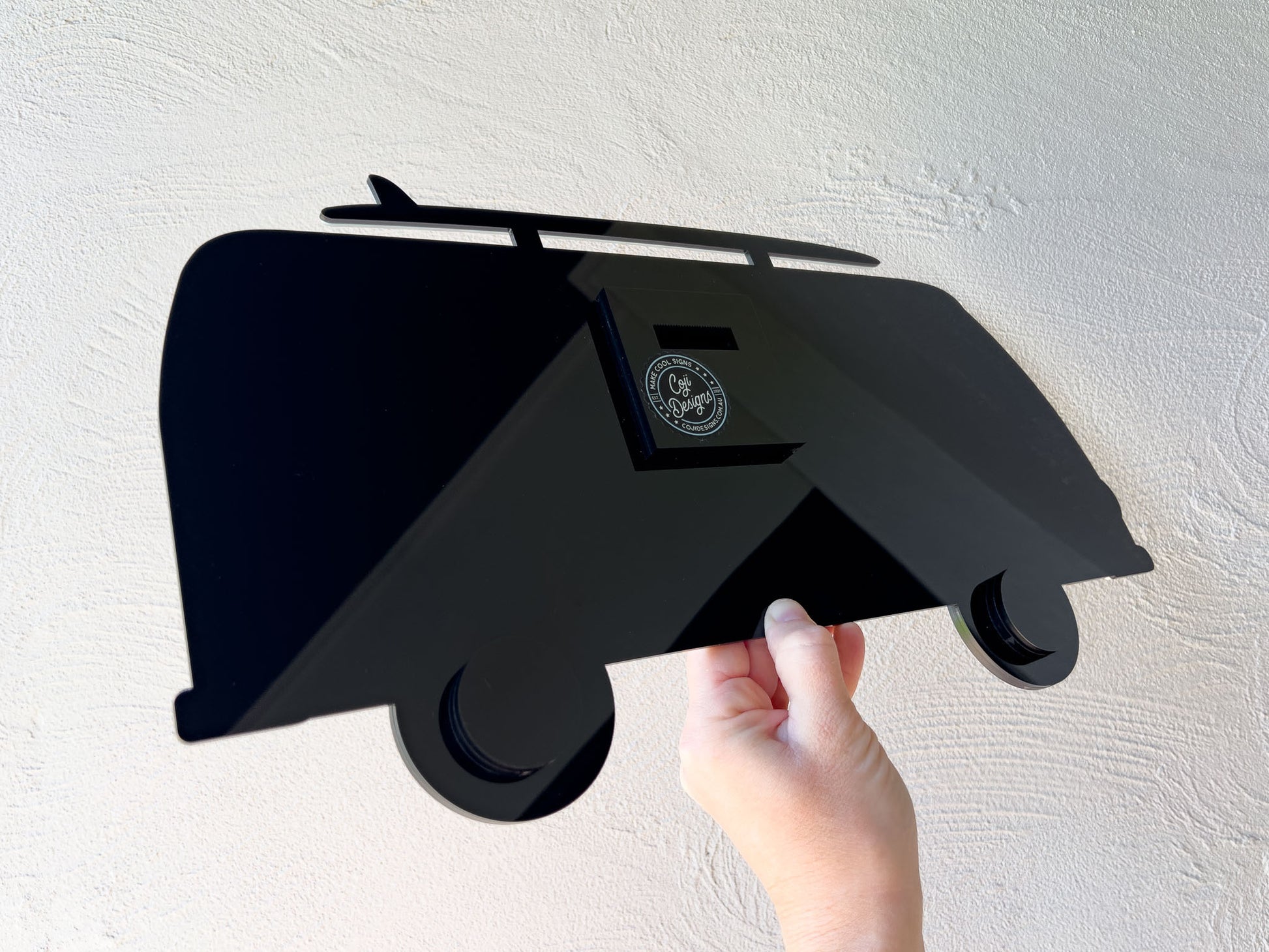 The back view of a Jagger surf bus sign showing a specialised custom made acrylic wall hanger.