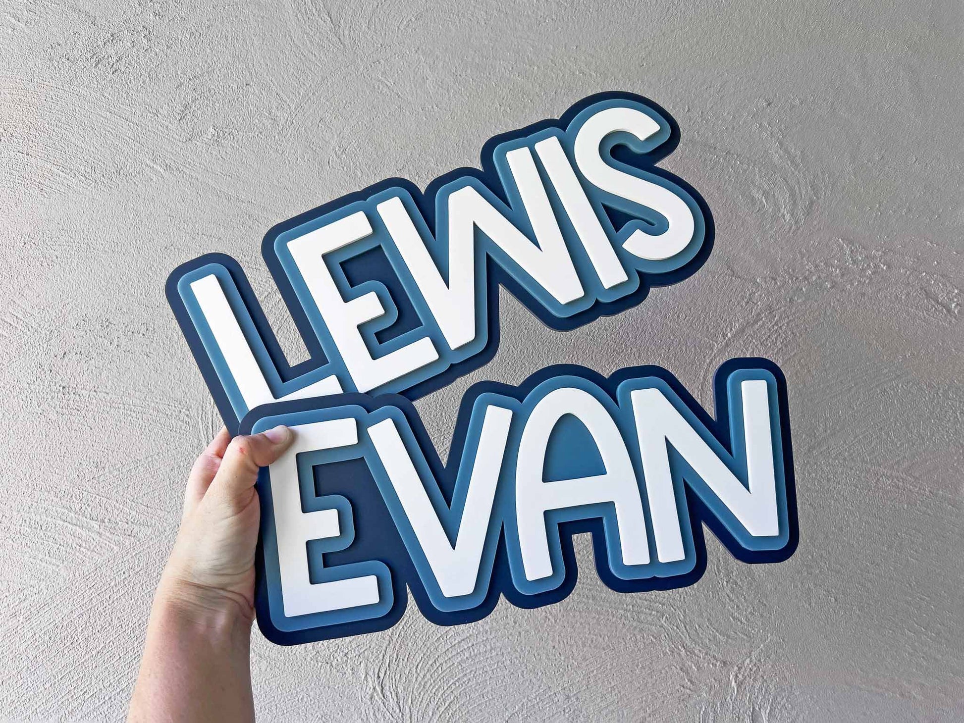 Coastal blue surfboard inspired custom wall lettering for kid's bedrooms that read 'LEWIS' & 'EVAN'