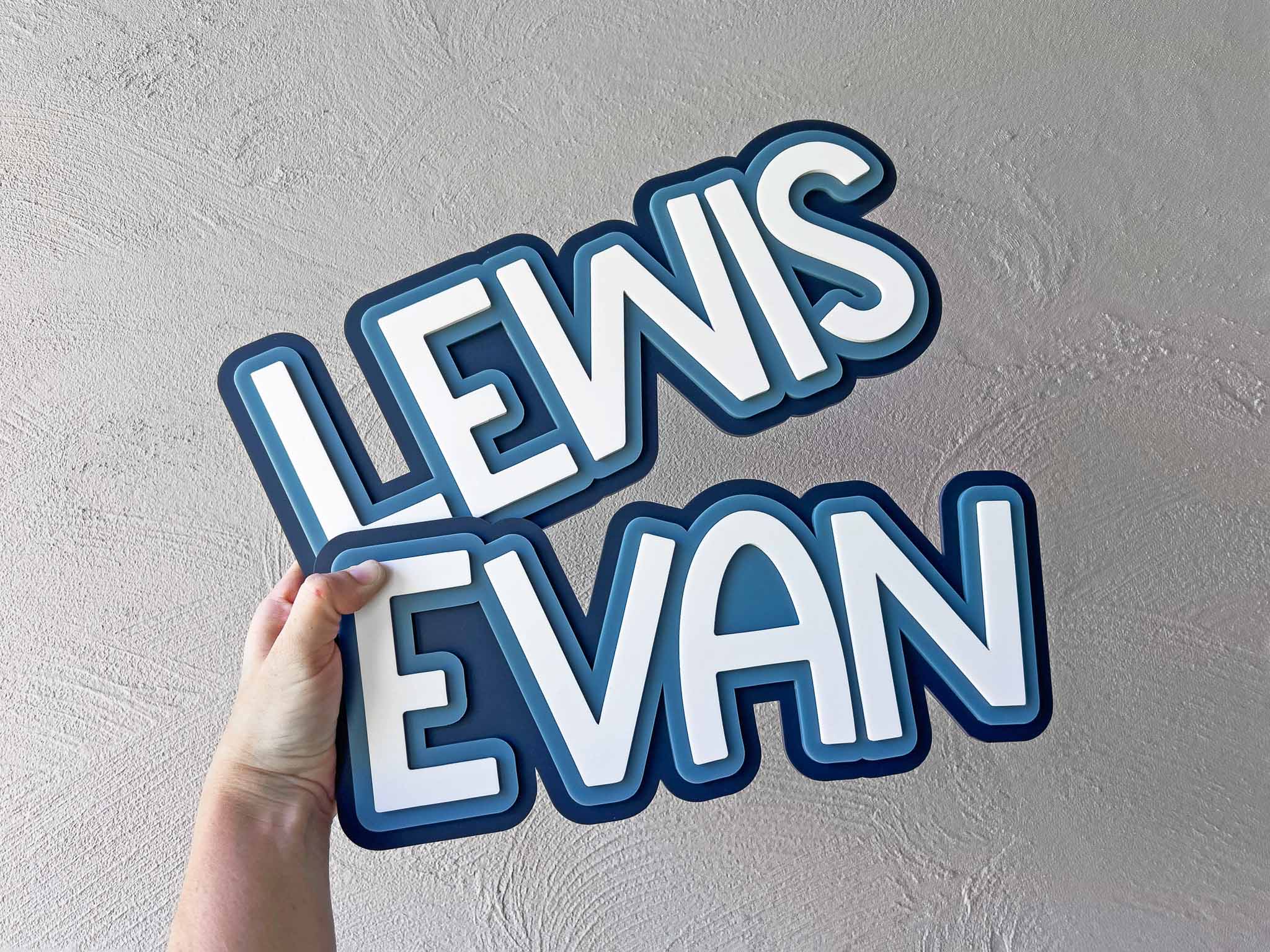 Coastal blue surfboard inspired custom wall lettering for kid's bedrooms that read 'LEWIS' & 'EVAN'