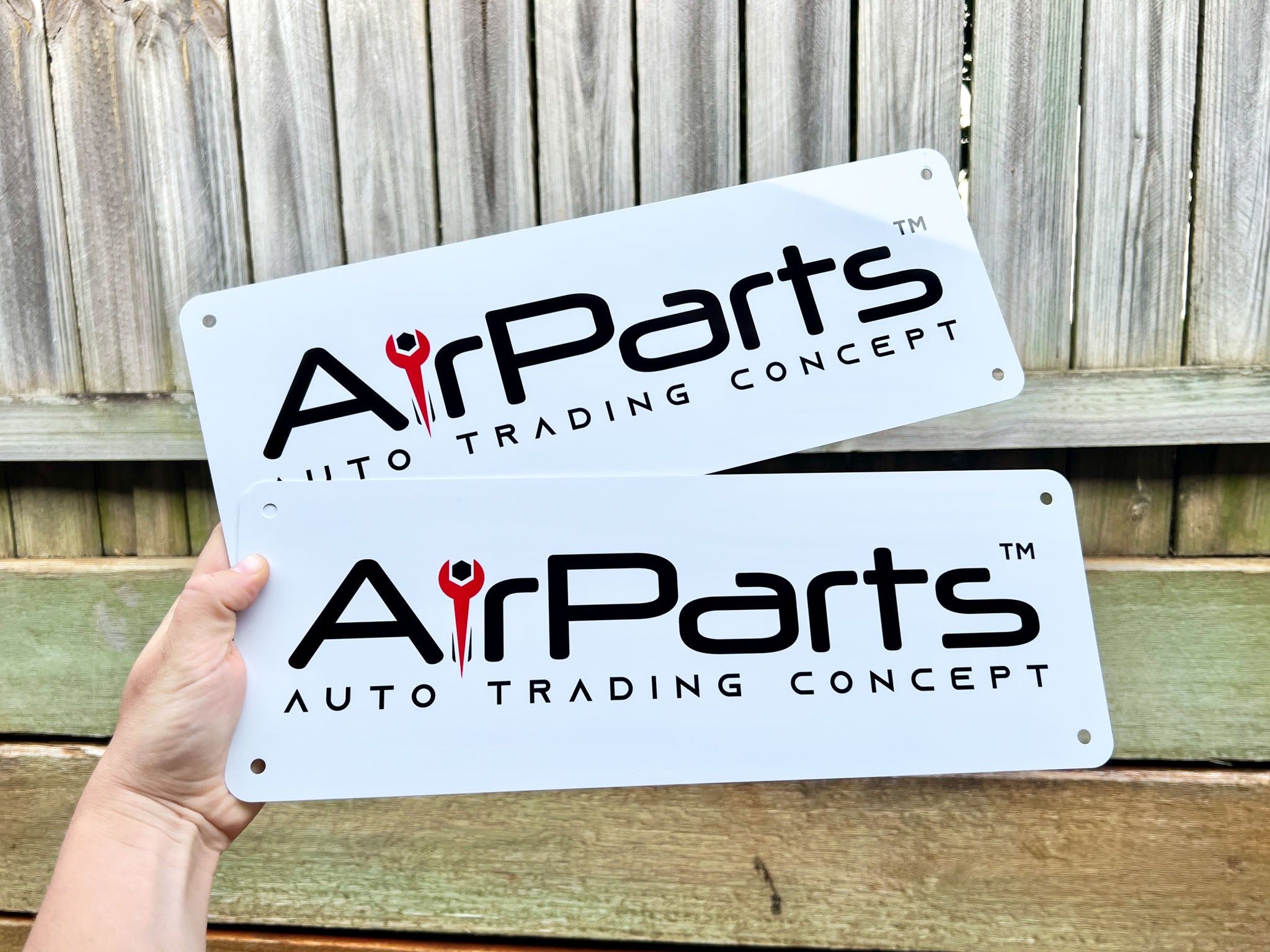 Two custom printed high gloss aluminium logo plates that read 'Airparts'.