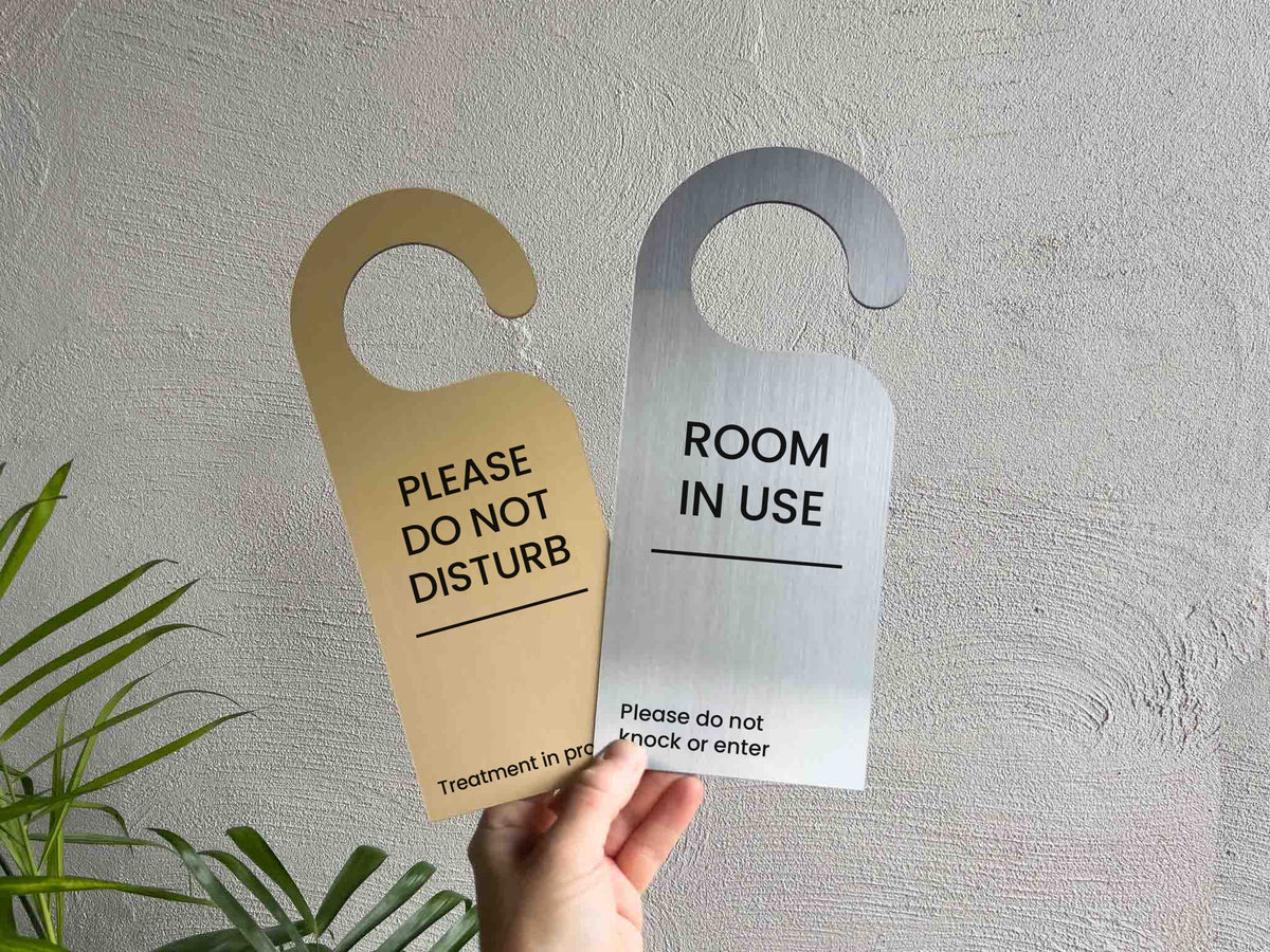 Two custom engraved brushed gold and silver do not disturb door hangers