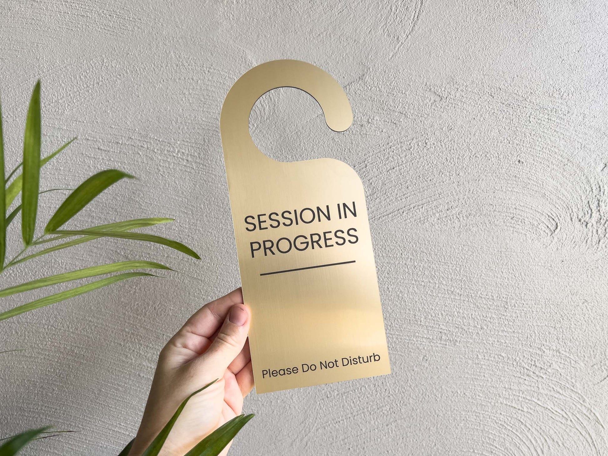 An elegant brushed gold and black custom made session in progress door hanger.