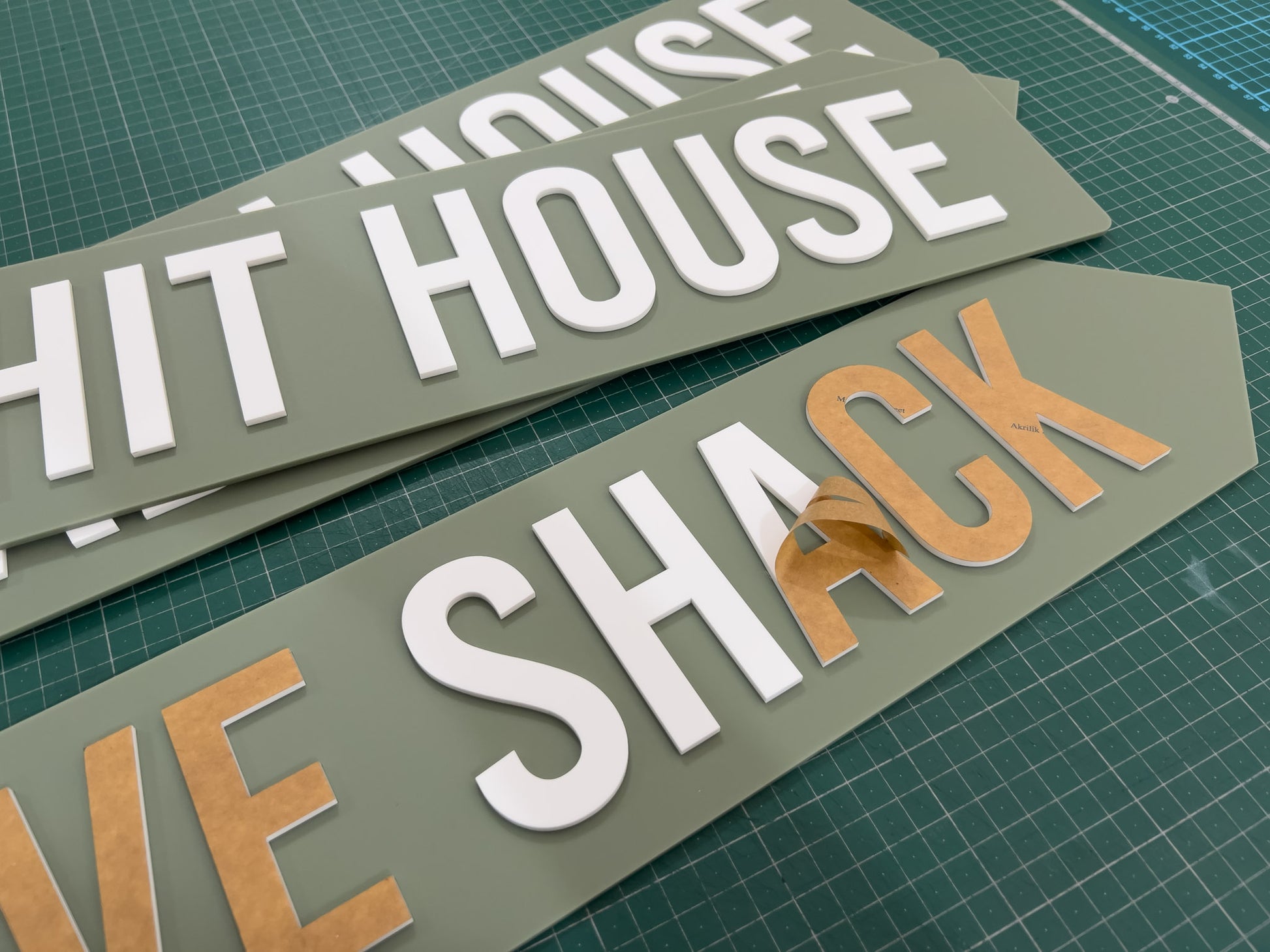A collection of Stockdale custom green and white signs being made
