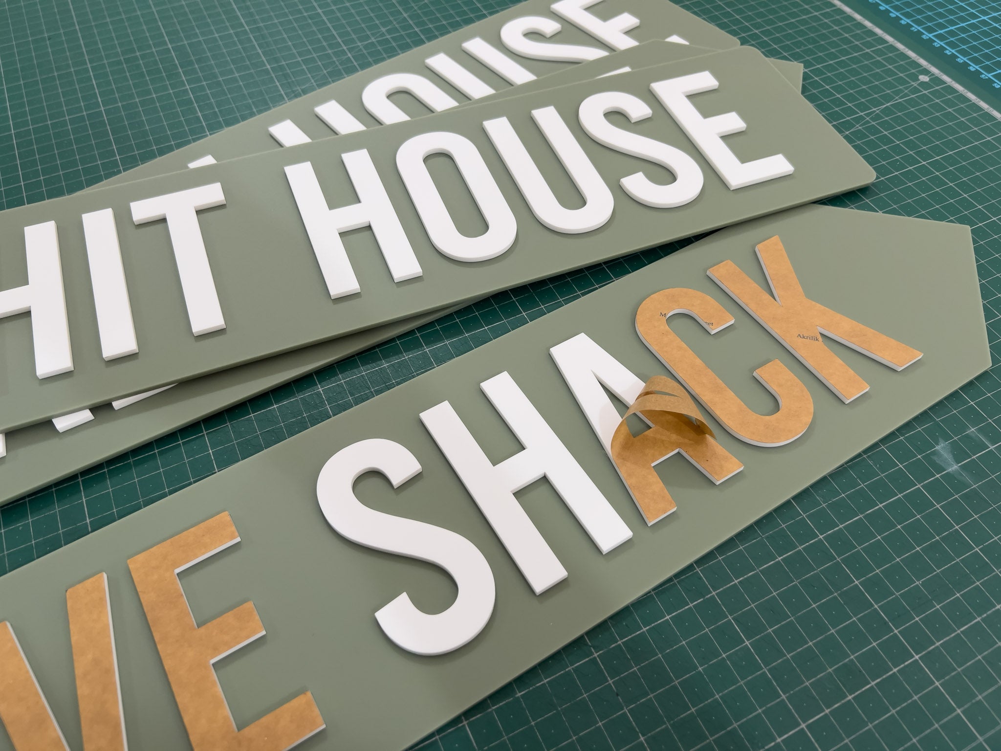 A collection of Stockdale custom green and white signs being made